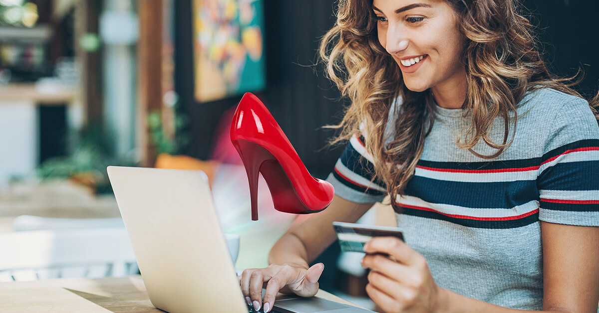 Smiling woman viewing red high heel shoe in AR